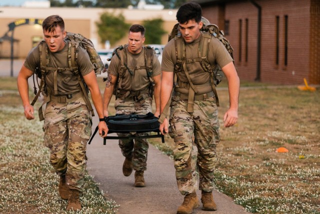 An Iron Squad carries a litter during the Iron Squad Challenge at Fort Novosel,  an event to commemorate the 30th anniversary of the Battle of Mogadishu on October 5, 2023.