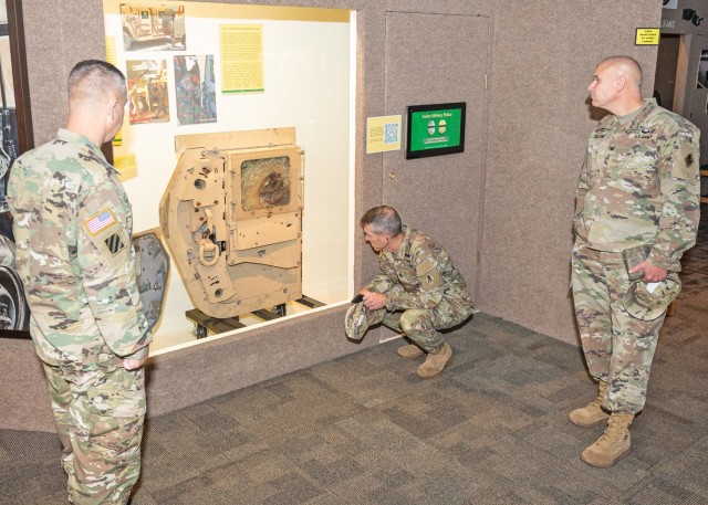 From right: Col. Kirt Boston, U.S. Army Military Police School assistant commandant, USAMPS Regimental Command Sgt. Maj. William Shoaf and Lt. Col. Robert Bonham, USAMPS chief of staff, look at a new exhibit Oct. 3 at the John B. Mahaffey Museum...