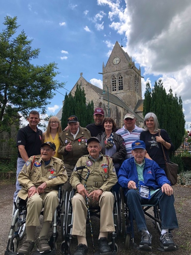 Liberty Jump Team Veterans’ Mission members escort World War II Veterans to Normandy in 2019. Back Row, L to R: Peter Plank, Linda Plank, WWII veteran George Merz, Dale Lindley, Wanda Stump, Butch Stump, Christel Ruts. Front row, L to R: WWII...