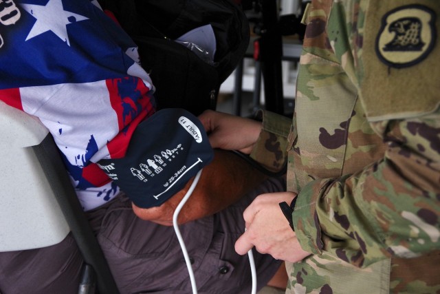 A medic from the 134th Ambulance Company out of Johnston, Iowa, checks the blood pressure of a veteran at the Five Seasons Stand Down resource fair in Cedar Rapids, Iowa, Sept. 7, 2023. The medics provided care for veterans and others experiencing homelessness. (U.S. Army National Guard photo by Sgt. 1st Class Jason Everett)