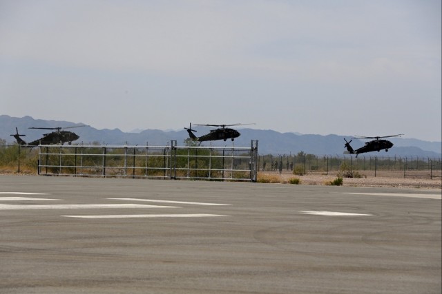 Black Hawk helicopters from Alpha Company, 5th Battalion, 101st Aviation Regiment, take off for an air assault mission during the Experimental Demonstration Gateway Event (EDGE) 2023 at U.S. Army Yuma Proving Ground in Yuma, Arizona.