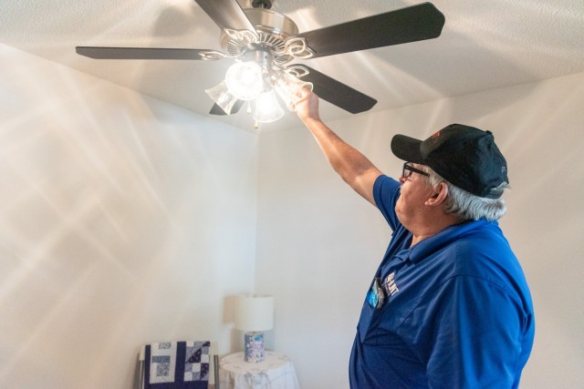 Michael Lindey changes a light bulb for a housing resident on Redstone Arsenal. He said he “loves the staff and the people here on Redstone Arsenal.”