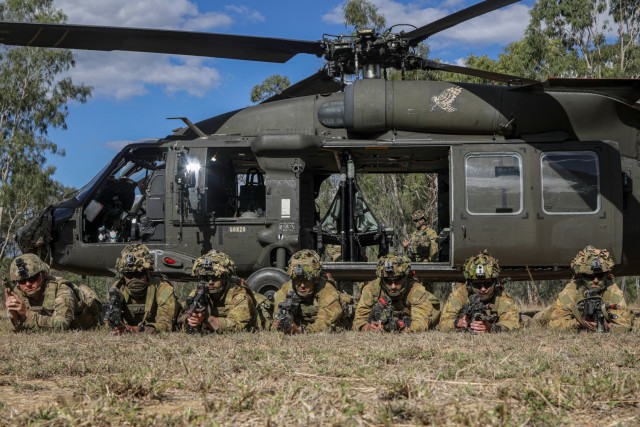 Soldiers from Australia’s defense force train in front of a UH-60 Black Hawk helicopter during Exercise Talisman Sabre in Queensland, Australia, July 22, 2023. The helicopter is assigned to 16th Combat Aviation Brigade, Task Force Warhawk, Battle Group Griffin.