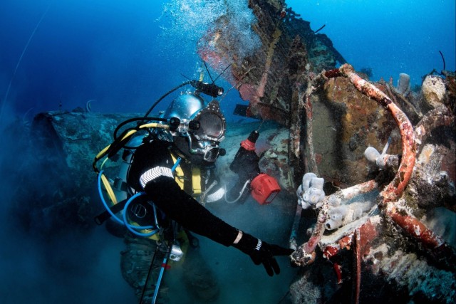 Diver works to excavate downed WWII aircraft