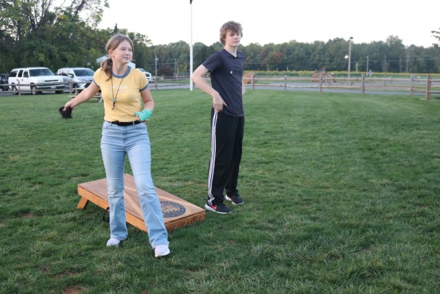 Military family members play cornhole