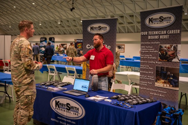 During the Transition Assistance Program’s Hiring Fair Oct. 12 in Nutter Field House, Chad Shephard with Kirby-Smith Machinery tells Staff Sgt. Randall Ayers about the heavy equipment and crane job opportunities available at the Oklahoma City...