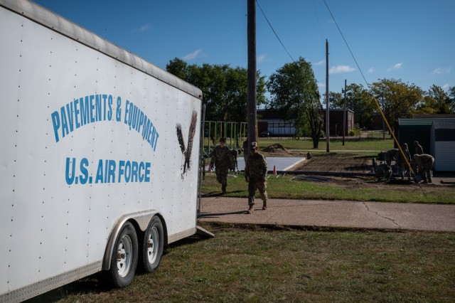 Students and instructors with Fort Leonard Wood’s U.S. Air Force 368th Training Squadron Pavements and Equipment Training course prepare the ground before laying concrete on Monday outside the 701st Military Police Battalion’s barracks. The...