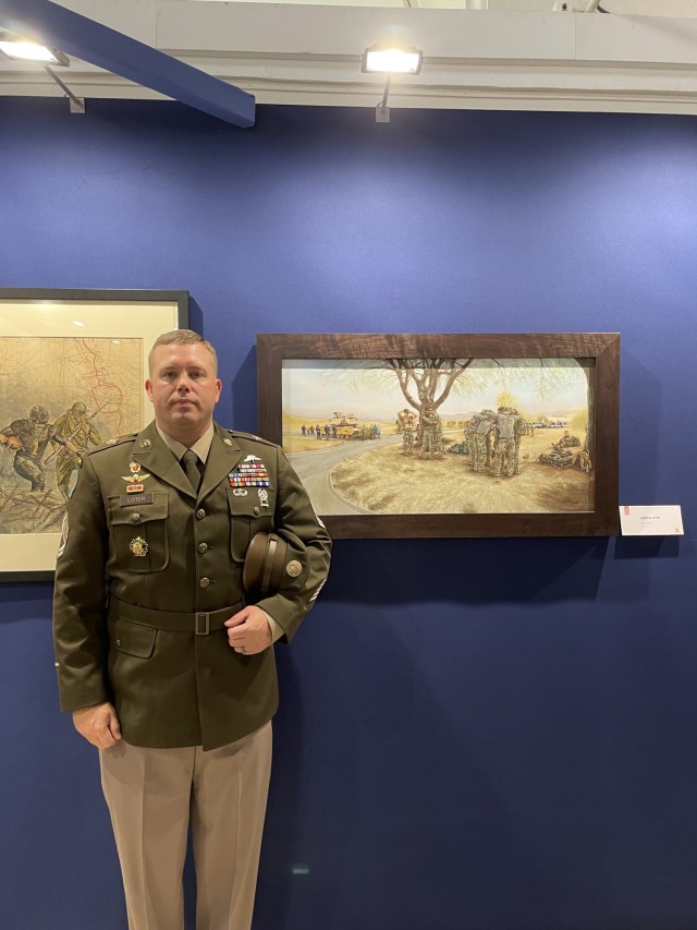 Sgt. 1st Class Curt Loter at the Exhibit with his artwork, &#34;Better with a Team.&#34;