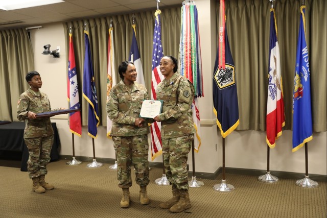 Staff Sgt. Aschlynd M. Spidell-Flores, right, information technology specialist assigned to the Enterprise Modernization Directorate, U.S. Army Human Resources Command, smiles Oct. 20, 2023, following a Soldier’s Medal award ceremony. Also pictured are Sgt. Ashlee Lowe, left, and Col. Jeanette Martin, center, director, EMoD. Spidell-Flores was awarded the medal for risking her life when pulling Dianna McMahan out of her smoldering vehicle Oct. 3, 2022, following a fatal car accident on U.S Route 31W. The Soldier’s Medal is the Army’s highest peacetime award for heroism. (Maria McClure, U.S. Army photo)