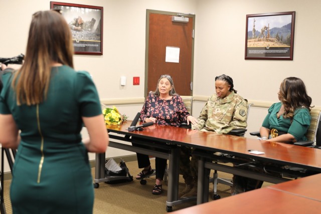 Staff Sgt. Aschlynd M. Spidell-Flores, center right, information technology specialist assigned to the Enterprise Modernization Directorate, U.S. Army Human Resources Command, gets emotional as Dianna McMahan, center left, describes the injuries she suffered from an Oct. 3, 2022, fatal car accident on U.S Route 31W. Spidell-Flores and Dianna McMahan were being interviewed by Christie Battista, reporter, WDRB TV-Louisville. Spidell-Flores was awarded the Soldier’s Medal for risking her life when pulling McMahan out of her smoldering vehicle following the accident. The Soldier’s Medal is the Army’s highest peacetime award for heroism. Also pictured is Angela Spidell, right, Spidell-Flores mother.