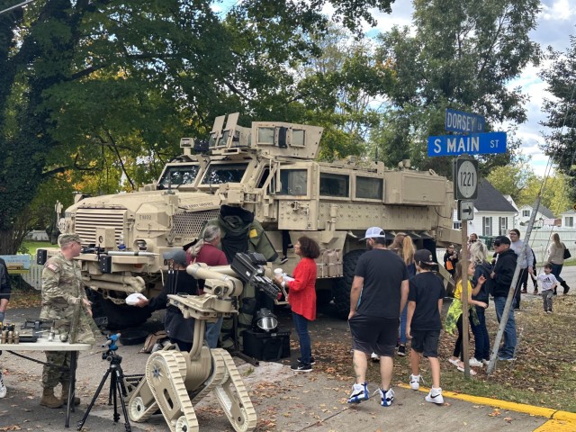 People looking at EOD equipment and an EOD modified MRAP during the Bowling Green Harvest Festival on October 20, 2023.