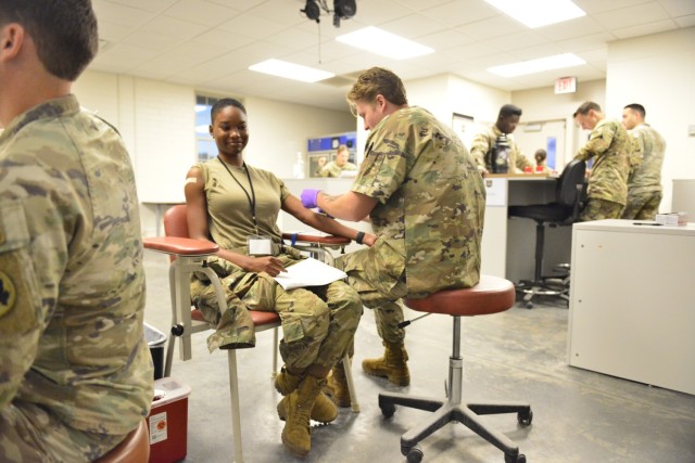 A medic attends to a Georgia Army National Guard Soldier during readiness processing Oct. 20 at Fort Stewart.