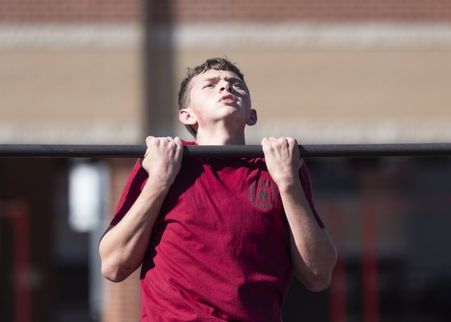 Junior ROTC Cadet Bryan Robertson, from the Scott Regional Technology Center Junior ROTC program, in Monett, Missouri, performs a pull up at the 31st Engineer Battalion quad, during the physical team tasks portion of the Raider Challenge event...