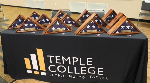Encased folded flags of the United States alongside congressional challenge coins, tokens of appreciation for the Congressional Veteran Commendation nominees, sit on display Oct. 7, 2023, at Temple College. 2023 marks the eighth year of the Congressional Veteran Commendation. (U.S. Army photo by Erick Rodriguez, Fort Cavazos Public Affairs)