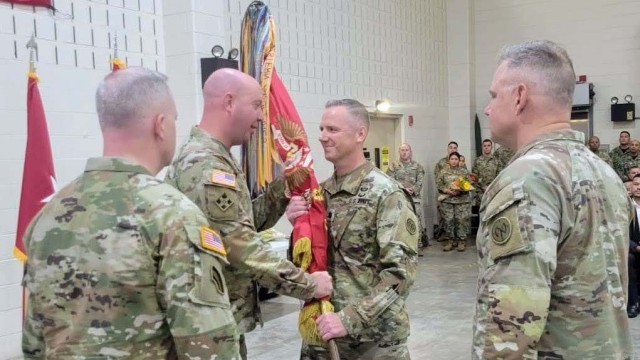 New York Army National Guard Lt. Col. Eric Emmerling, a field artillery officer assigned to 1st Battalion, 258th Field Artillery, 27th Infantry Brigade Combat Team, accepts the flag of the battalion from Col. Bradley Frank, the commander of the 27th Infantry Brigade, during a change-of-command ceremony at Camp Smith in Cortland Manor, N.Y., Oct. 20, 2023. He replaced Lt. Col Jeffery Roth, who led the field artillery unit, whose lineage dates back to the 1780s, since 2021. (Courtesy Photo)