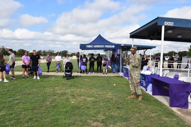 Col. Timothy Gatlin, 1st Cavalry Division Artillery Brigade, 1st Cavalry Division,  commander, addresses attendees after the annual Domestic Violence Awareness Walk Oct. 4 at III Armored Corps Headquarters. Gatlin thanked the attendees for supporting the event and expressed gratitude to the Family Advocacy Program for their efforts. (U.S. Army photo by Janecze Wright, Fort Cavazos Public Affairs)