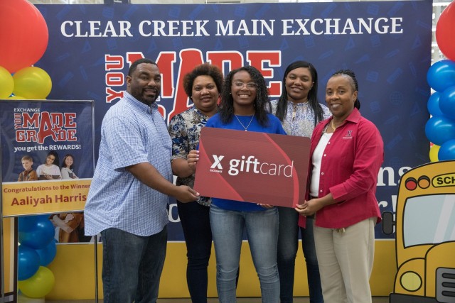 Aaliyah Harris was the first-place winner of the AAFES You Made the Grade Program and was awarded a $2,000 gift card to use at the Exchange on Oct. 6 at the Clear Creek Exchange. She received the recognition surrounded by her family and AAFES staff. (U.S. Army photo by Blair Dupre, Fort Cavazos Public Affairs)
