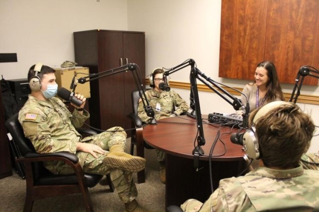 Then-Spc. Garrett Dacko and Cpl. Kyra Pearl, 11th Corps Signal Bde., interview guests on Fort Hood’s Great Big Podcast, while host Samantha Harms, Fort Hood Public Affairs, controls the levels during a podcast recording Monday at III Corps Headquarters. The podcast celebrated its 100th episode Dec. 2, 2021. 
