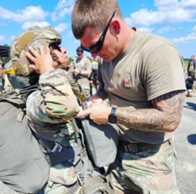 Sgt. 1st Class Dylon Dibble inspects 2nd Lt. Menna Mohamed ahead of an airborne operation on Sicily Drop Zone during the unit&#39;s celebratory jump.