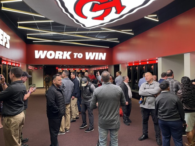 Information Operations Qualification Course students view and take pictures in front of Kansas City Chiefs player lockers, including Patrick Mahomes, Travis Kelce and Harrison Butker, Oct. 20, 2023. 