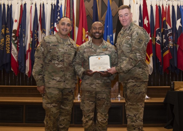 Maj. Gen. Christopher Beck, Maneuver Support Center of Excellence and Fort Leonard Wood commanding general (right), and MSCoE and Fort Leonard Wood Command Sgt. Maj. Jorge Arzabala (left), pose for a photo Wednesday in Lincoln Hall Auditorium with...