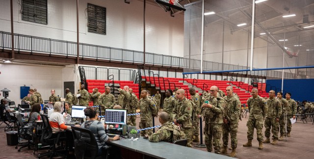 Trainees with Company F, 2nd Battalion, 10th Infantry Regiment, meet with agents from Leisure Travel Services Monday at Davidson Fitness Center to buy tickets and make reservations to go home during the holidays. The temporary travel agency will be set up in the DFC gym through December to facilitate booking more than 4,500 combinations of flights and direct charter bus tickets for service members this holiday season.