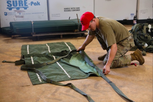 U.S. Army Parachute Rigger prepares to rig