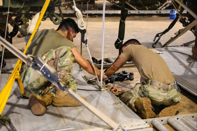 U.S. Army Parachute Riggers mount airdrop equipment