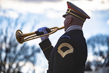 A bugler from the Army Band, &#34;Pershing&#39;s Own&#34;, plays “Taps” during a Presidential Armed Forces full honors wreath-laying ceremony at the Tomb of the Unknown Soldier at Arlington National Cemetery, January 20, 2020.