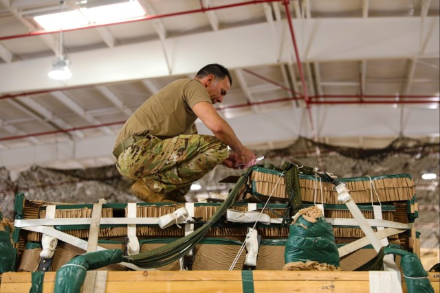 U.S. Army Parachute Rigger checks to ensure cargo was rigged correctly
