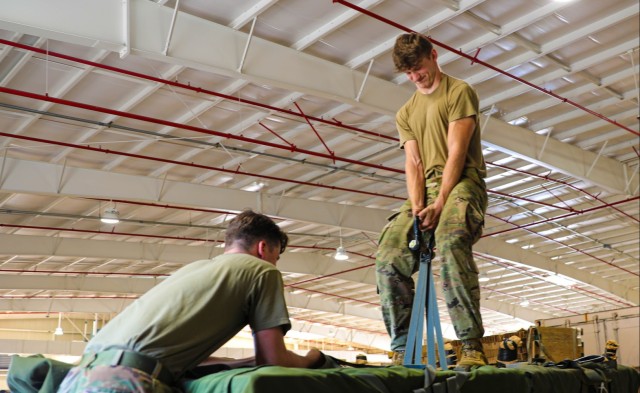 U.S. Army Parachute Riggers lift equipment