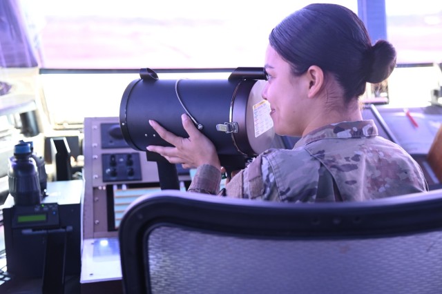 Specialist Jennifer Arreola surveys the airfield with vigilant eyes,, ensuring the orchestrated flow of air traffic is seamless and safe.