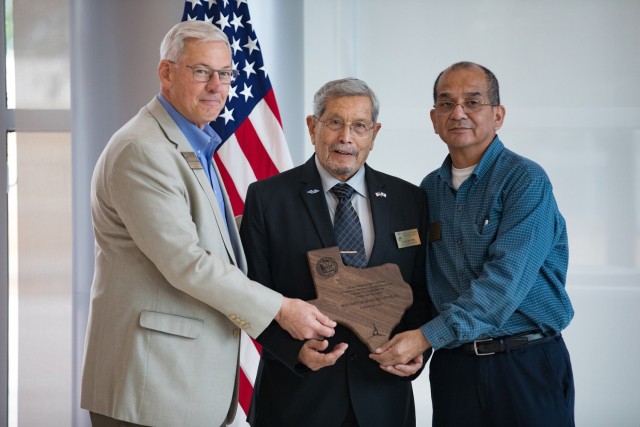 Retired Sgt. Maj. Guadalupe Lopez receives the honorary retiree award from the Fort Cavazos Soldier for Life Council, presented by Oscar Anderson and Jerry Hernandez, during the opening ceremony of Retiree Appreciation Day. (U.S. Army photo by Blair Dupre, Fort Cavazos Public Affairs)