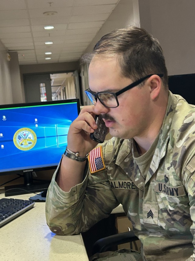 Sgt. Kenneth Palmore, a human resources specialist and Native American, with the 369th Adjutant General Battalion, a, answers phone calls.