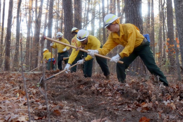 Virginia National Guard Soldiers and Airmen conduct the field day exercise portion of wildland firefighter training with the Virginia Department of Forestry Nov. 12, 2023, at Fort Barfoot, Virginia. They focused on basic tools, familiarization with bulldozers and engines, fireline construction and proper fire shelter use. (U.S. National Guard photo by Cotton Puryear)