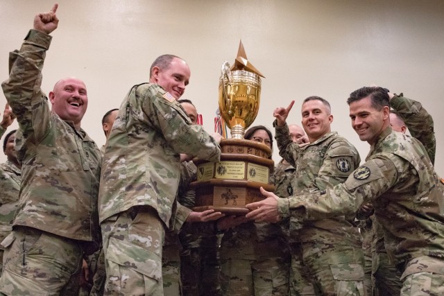 Soldiers with the 89th Military Police Brigade celebrate earning the Commander&#39;s Cup for the third year in a row during the Phantom Warrior Awards Nov. 1 at the Main Post Chapel. This year, they accumulated 670 points, surpassing the second-place team by more than 345 points. (U.S. Army photo by Blair Dupre, Fort Cavazos Public Affairs)