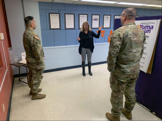 U.S. Army Yuma Proving Ground (YPG) Commander Col. John Nelson (right, foreground) and Command Sgt. Maj. Mark Millare (left) receive a tour of the Yuma Sun newspaper&#39;s &#39;Newseum&#39; from editor Roxanne Molenar after meeting with the Yuma...