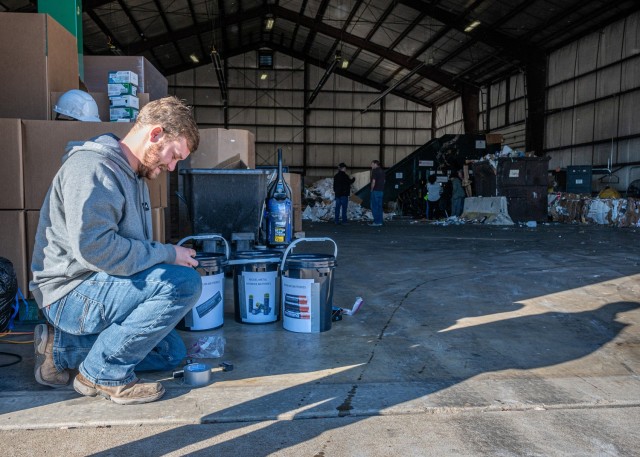 Wyatt Wilt, an environmental technician helping with the America Recycles Day e-waste collection Wednesday at the Fort Leonard Wood Recycling Center, sorts through dropped-off batteries.
