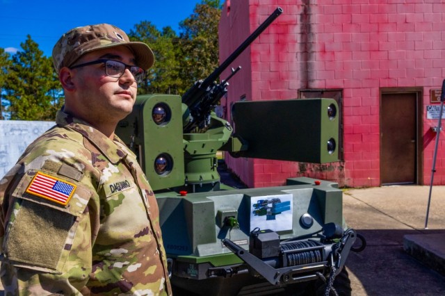 U.S. Army Spc. John Daguanno, K Troop, 2nd Squadron, 11th Armored Cavalry Regiment, Fort Irwin, Calif., views robotic systems, after presenting feedback as panel member during the Human Machine Integration Summit II, Oct. 17, 2023, at Fort Moore, Ga. To further plan leveraging advanced machines to offload tactical risk to Soldiers, minimize cognitive load, and integrate robots into Army formations, Army Futures Command and MCoE hosted the second HMI Summit, Oct. 17-19. 
