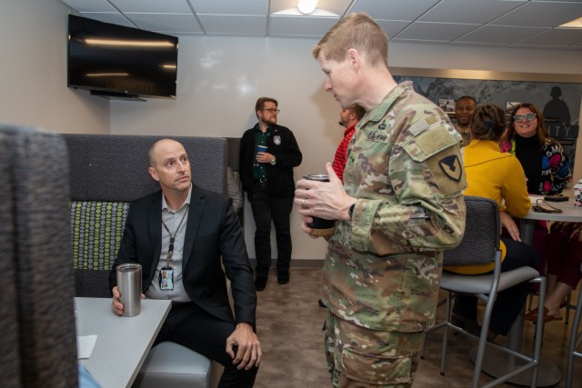 The U.S. Army Security Assistance Command&#39;s commanding general, Brig. Gen. Brad Nicholson (right), connects with staff members at the command&#39;s New Cumberland Pennsylvania headquarters during a Donuts with the CG session.