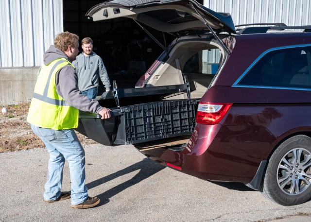 Landon Veasman, a recycling laborer and equipment operator here, attempts to remove a television from a vehicle Wednesday at the Recycling Center, during an America Recycles Day e-waste collection event.