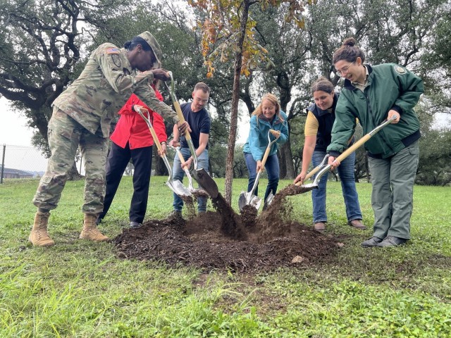 U.S. Army Garrison-Fort Cavazos Commander Col. Lakicia R. Stokes, Directorate of Public Works officials and Camille Wiseman with Texas A&M Forest Service plant a bur oak tree Nov. 9 at the Sportsmen’s Center picnic area, commemorating the 18th consecutive year as a Tree City USA community. (U.S. Army photo Christine Luciano, DPW Environmental)