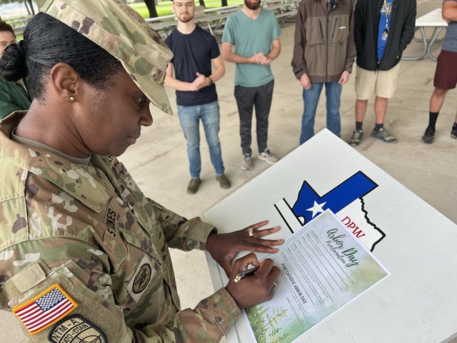 U.S. Army Garrison-Fort Cavazos Commander Col. Lakicia Stokes signs a proclamation to announce Nov. 9, 2023, as Fort Cavazos Arbor Day, encouraging stewardship of the installation’s natural resources and appreciation of trees. (U.S. Army photo by Christine Luciano, DPW Environmental)