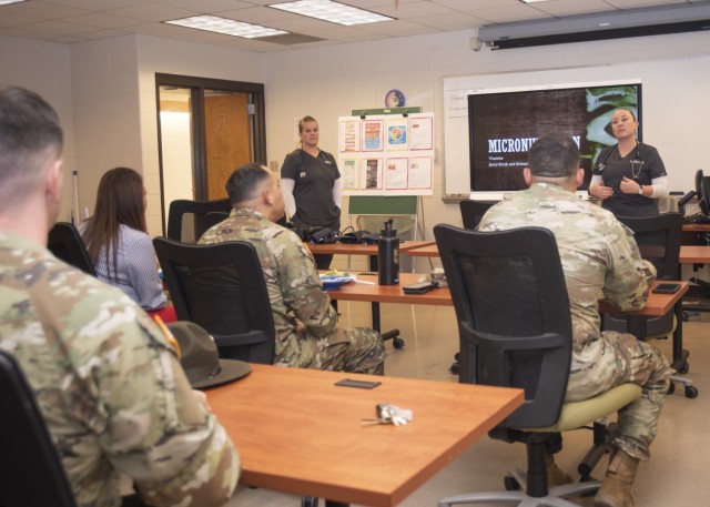 Lincoln University nursing students Jenny Brock (right) and Brittoni Matchell brief service members and civilians on micronutrition Tuesday in Bldg. 499, as Fort Leonard Wood’s Truman Army Education and Personnel Testing Center hosts a week of...