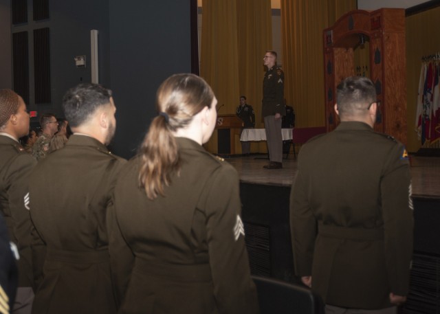 Cpl. James Lizotte, with the Maneuver Support Center of Excellence Office of the Staff Judge Advocate, leads a recitation of the NCO Creed during an NCO induction ceremony Friday in Abrams Theater, where 21 NCOs from across the installation were...