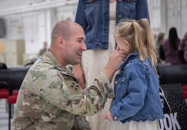 A U.S. Army Soldier of 4th Battalion, 4th Aviation Regiment, 4th Combat Aviation Brigade, 4th Infantry Division, pinches his daughter&#39;s cheek at the battalion&#39;s homecoming ceremony on Fort Carson, Colo., Oct. 23, 2023. 