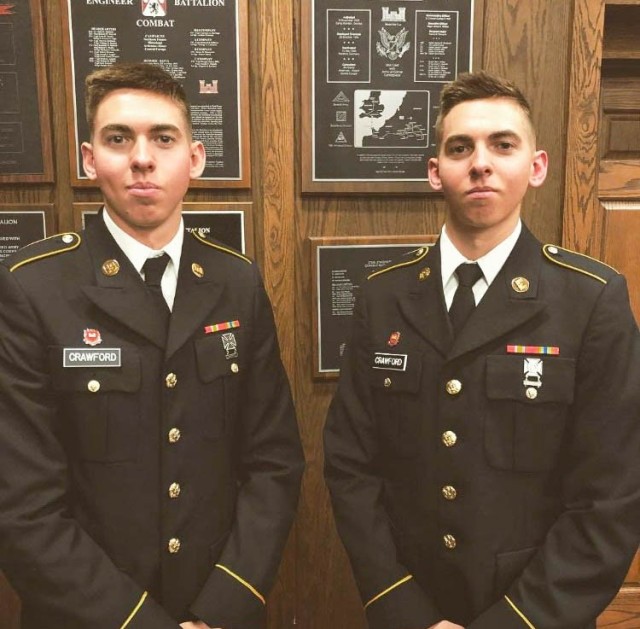 U.S. Army Pvt. Shane (right) and Shawn Crawford, heavy equipment operators, with 1st Brigade, 102nd Training Division, pose for a photo after graduating Horizontal Construction Engineer School at Fort Lenard Wood, Missouri, Jan. 2018. (Curtesy)