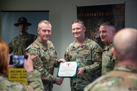 Sgt. 1st Class Craig Pienkoski, an Army Reserve component career counselor assigned to 4th Infantry Division, is awarded the Meritorious Service Medal by Maj. Gen. William B. Dyer III and Command Sergeant Major Juddiah Mooso from the 108th Training Command Initial Entry Training at Fort Carson, Colo., Nov. 17, 2023. Pienkoski received the award for transitioning the largest number of Soldiers from the active-duty component into the Army Reserve Component Drill Sergeant Program by any individual in the entire Army worldwide this year. 
