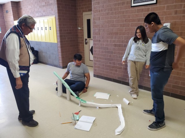 Students participate in a team building exercise by creating their own roller coaster during a Navigate the Future Program workshop. 