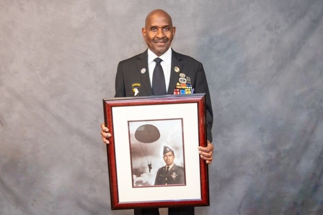 Hall of Heroes inductee Ronald Wright holds a portrait honoring his service. 
